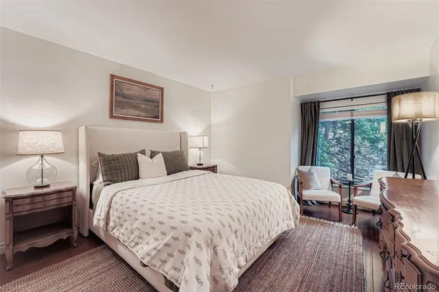 a bedroom with bed and a large window