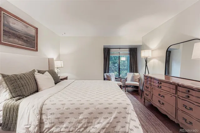 a bedroom with a large bed and a large mirror