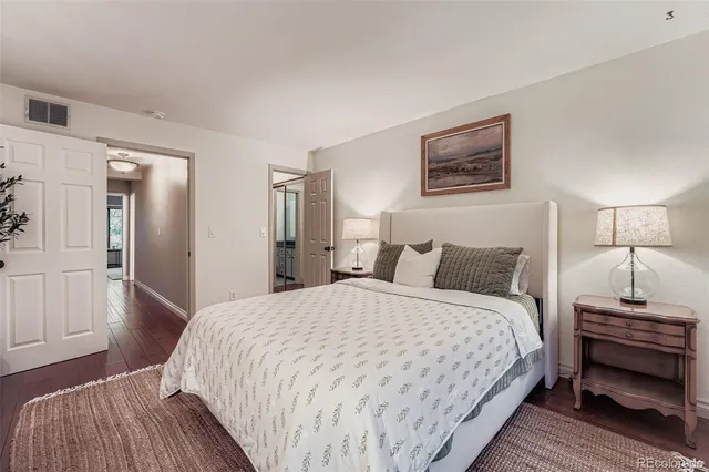 a bedroom with a bed and a lamp