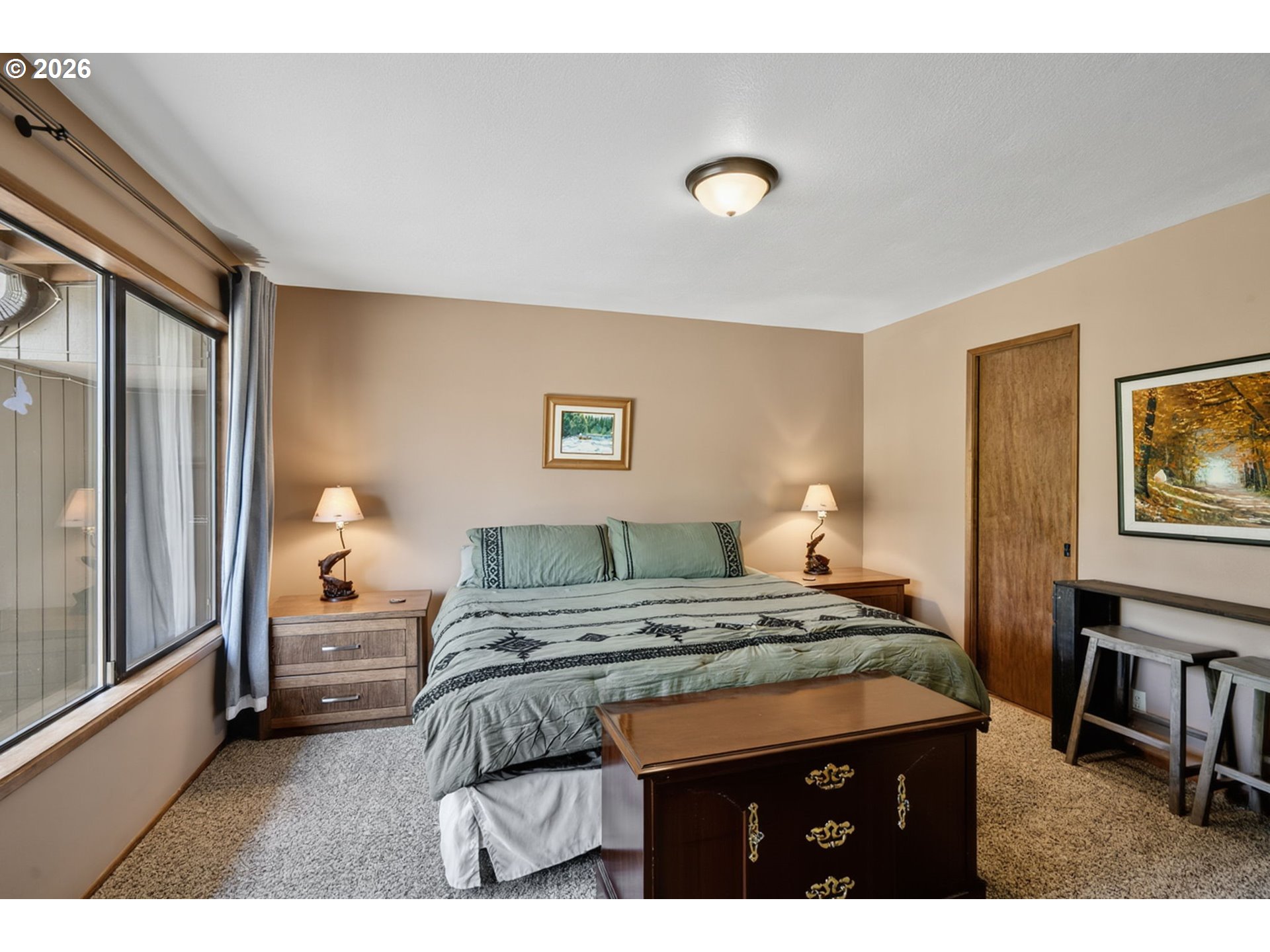 46725 Goodpasture Road Vida, OR 97488 - Photo 10 of 48 a bedroom with a bed and a lamp