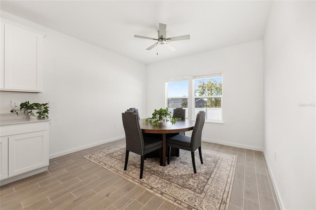 8972 Southwest 69th Terrace Ocala, FL 34476 - Photo 12 of 42 a view of a dining room with a table and chairs