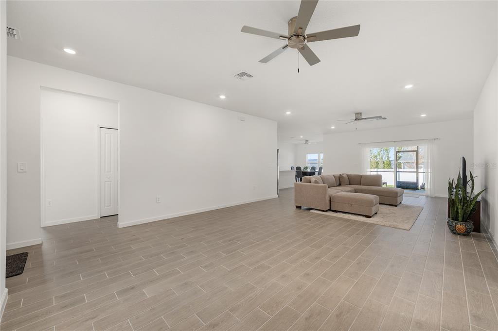 8972 Southwest 69th Terrace Ocala, FL 34476 - Photo 16 of 42 a living room with furniture and a ceiling fan