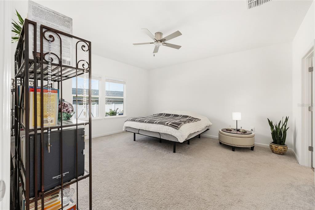 8972 Southwest 69th Terrace Ocala, FL 34476 - Photo 18 of 42 a bedroom with furniture and window