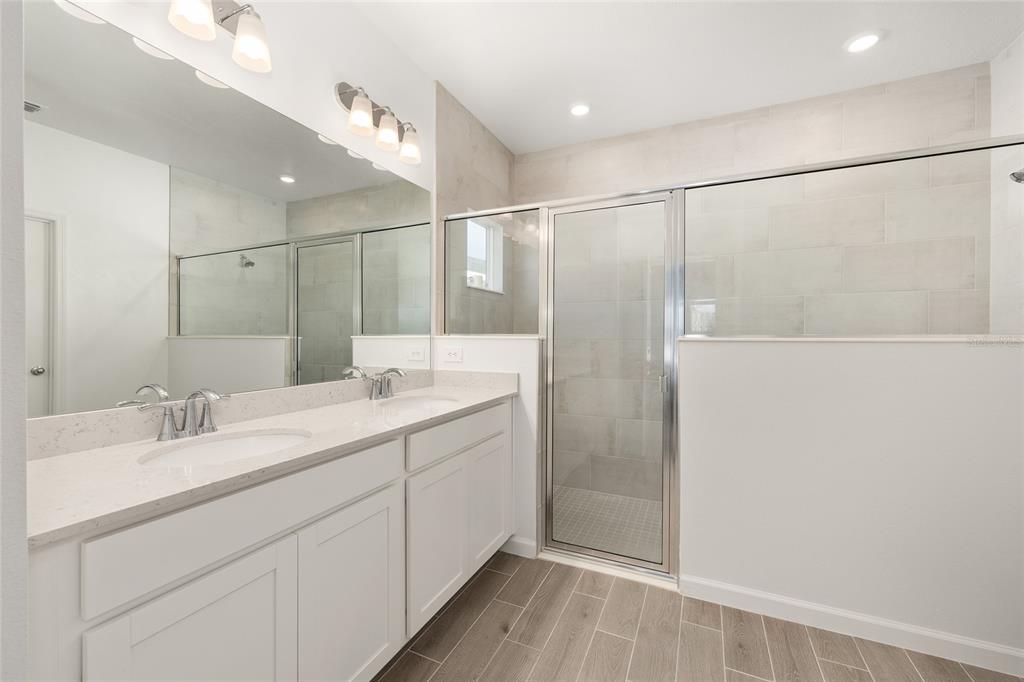8972 Southwest 69th Terrace Ocala, FL 34476 - Photo 21 of 42 a bathroom with a double vanity sink and mirror