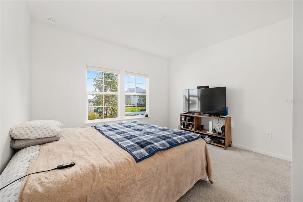 8972 Southwest 69th Terrace Ocala, FL 34476 - Photo 25 of 42 a bedroom with a bed and a television