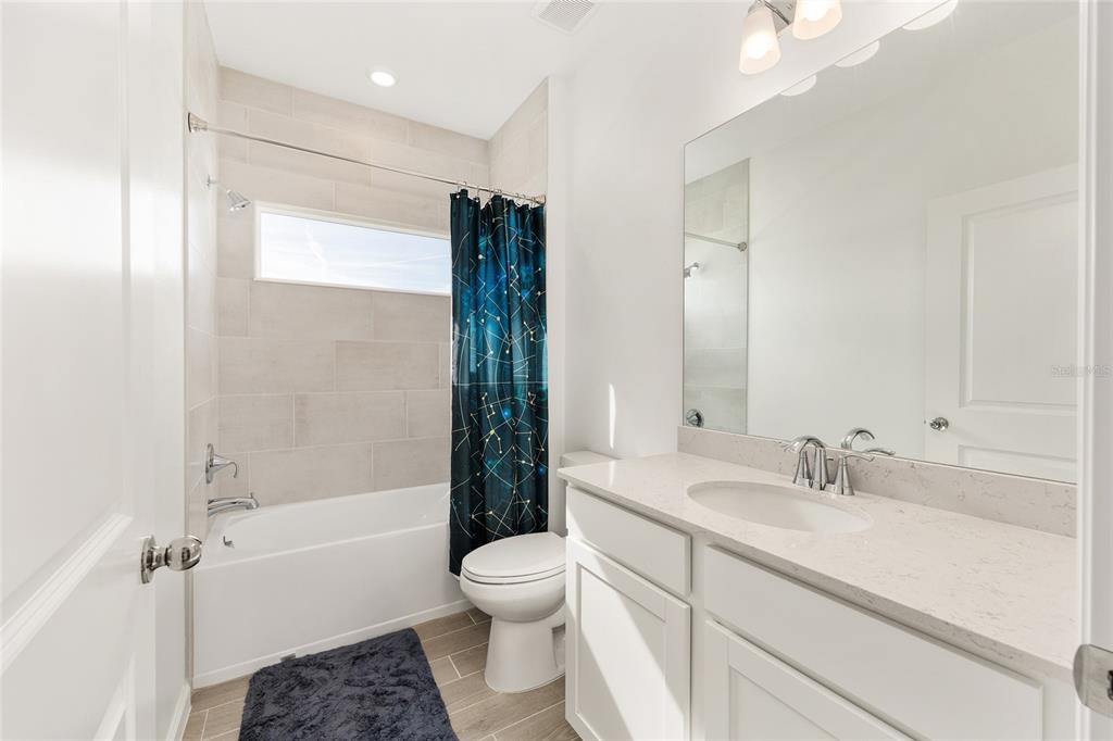 8972 Southwest 69th Terrace Ocala, FL 34476 - Photo 28 of 42 a bathroom with a sink a toilet and shower