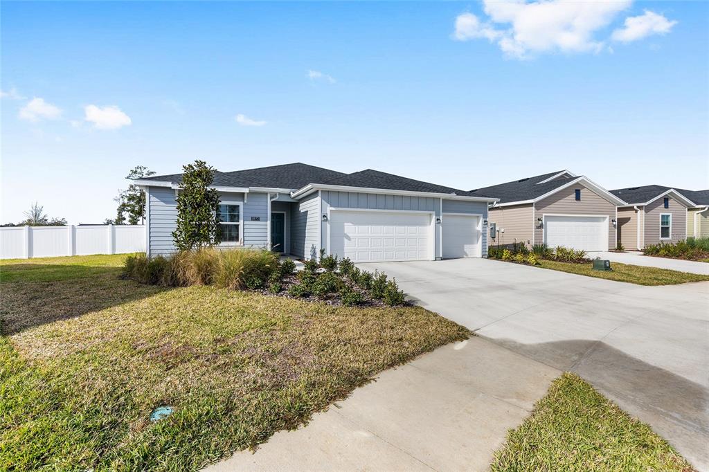 8972 Southwest 69th Terrace Ocala, FL 34476 - Photo 42 of 42 a front view of a house with a garden