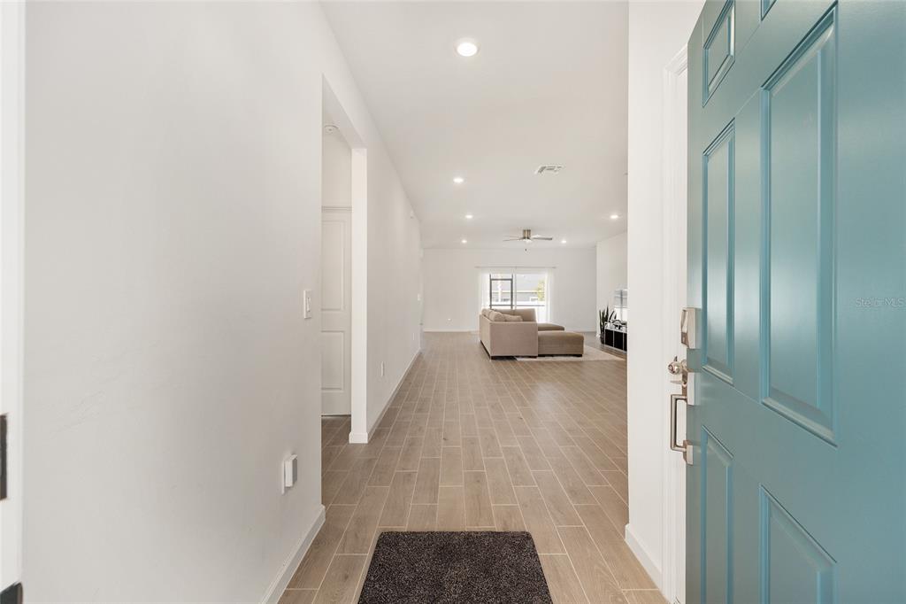 8972 Southwest 69th Terrace Ocala, FL 34476 - Photo 5 of 42 a view of empty room with wooden floor