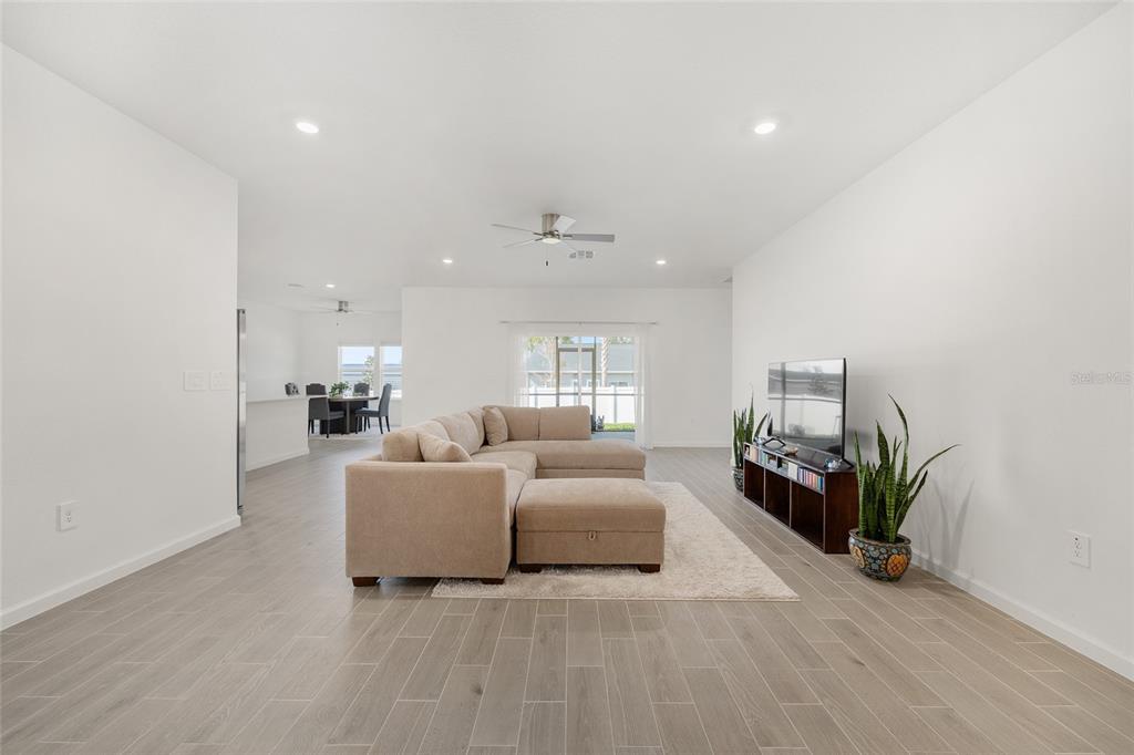 8972 Southwest 69th Terrace Ocala, FL 34476 - Photo 7 of 42 a living room with furniture and a fireplace