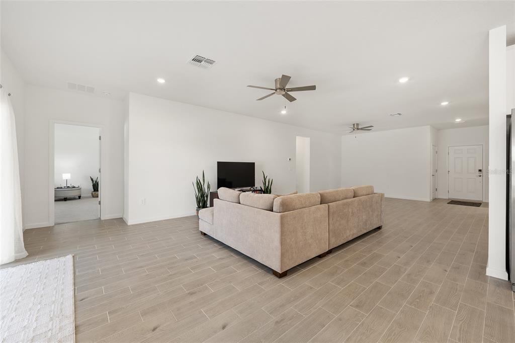 8972 Southwest 69th Terrace Ocala, FL 34476 - Photo 8 of 42 a living room with furniture and a flat screen tv