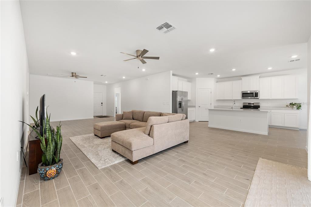 8972 Southwest 69th Terrace Ocala, FL 34476 - Photo 9 of 42 a living room with furniture and a kitchen view