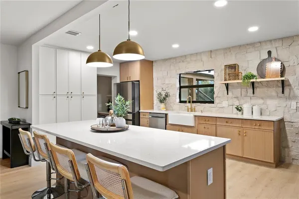 a kitchen with a table and chairs in it
