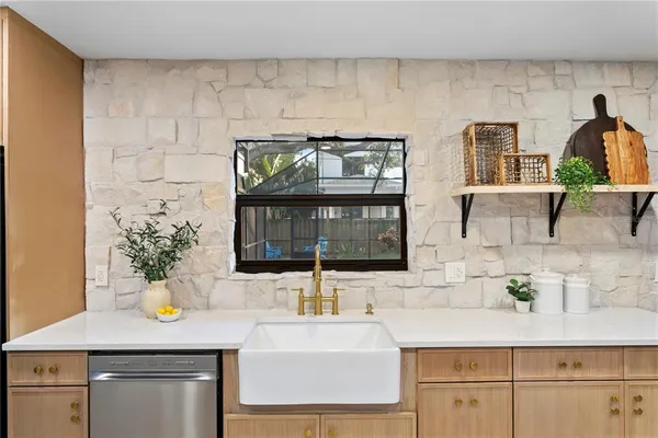 a kitchen with a sink stainless steel appliances and cabinets