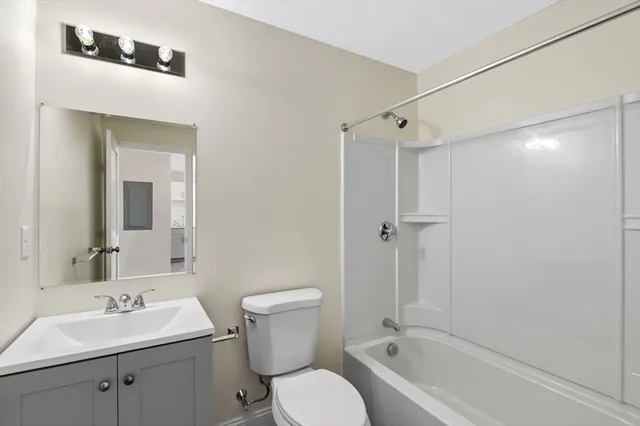 a bathroom with a toilet sink shower and mirror