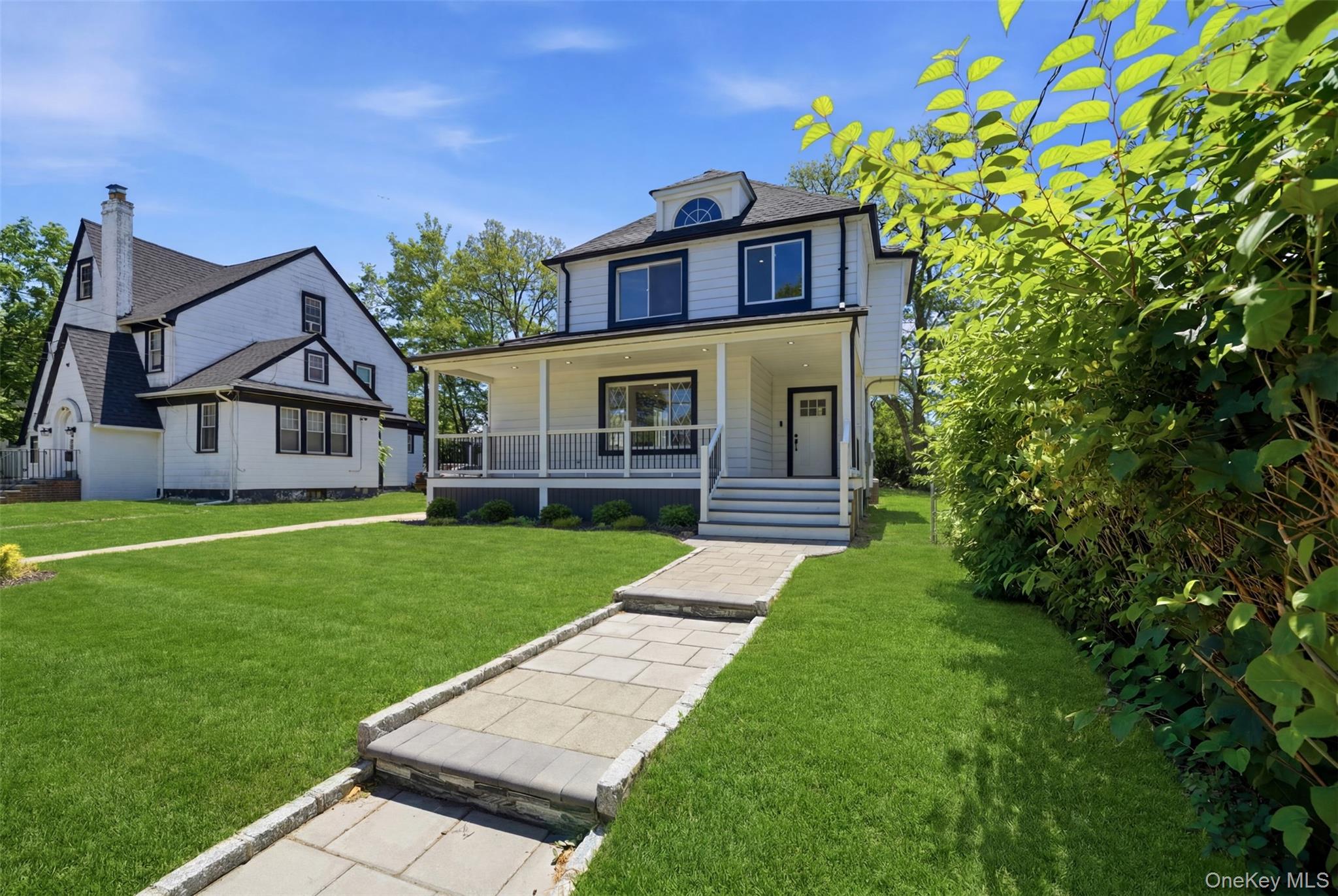 135 Whaley Street Freeport, NY 11520 - Photo 2 of 38 a front view of a house with a yard
