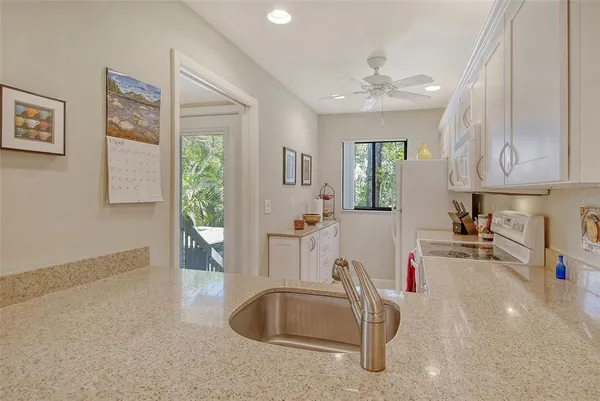 a kitchen with appliances a sink and a window