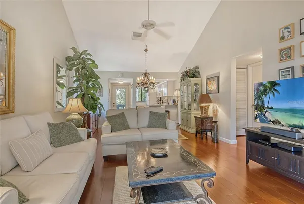 a living room with furniture a rug and a table
