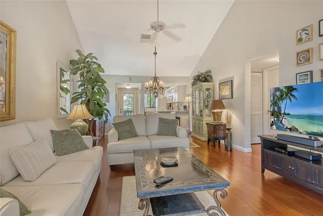 a living room with furniture a rug and a table