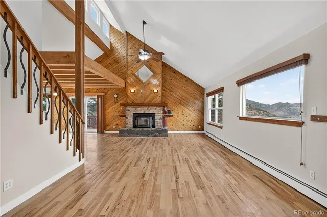 a view of empty room with stairs and fireplace