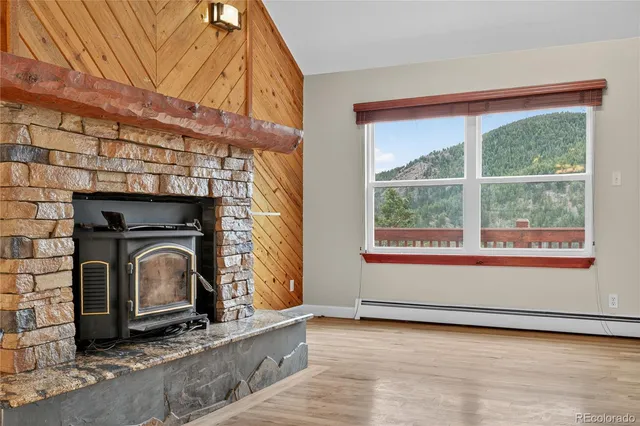 a living room with fireplace and a wooden floor