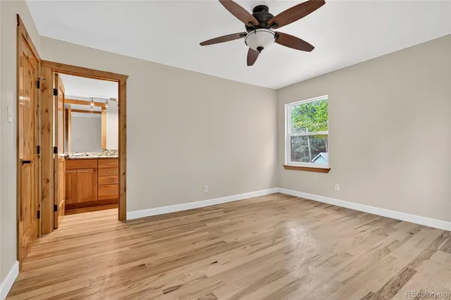 wooden floor in an empty room with a window