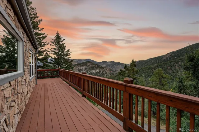 a view of balcony with wooden floor and fence