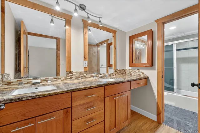 a bathroom with a granite countertop sink and a mirror