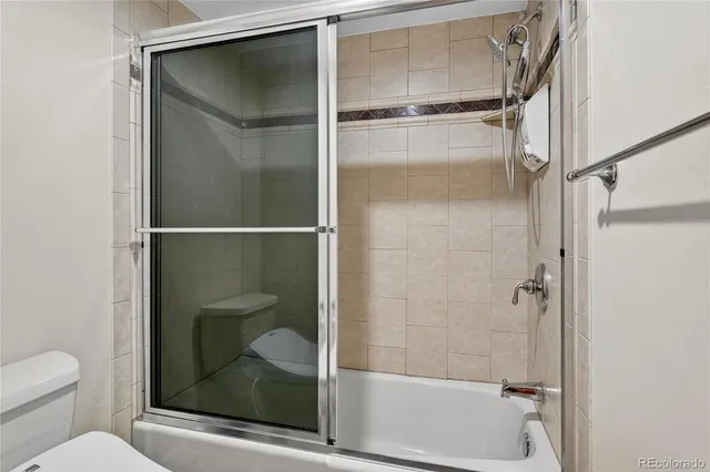 a bathroom with a shower and toilet
