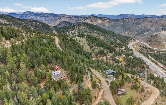 a view of a dry yard with mountains in the background