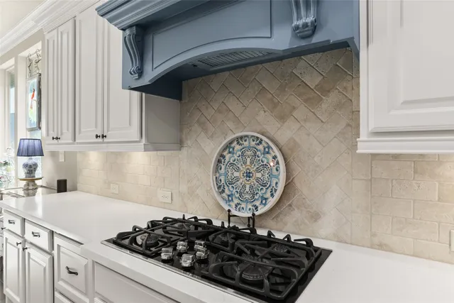 a kitchen with a stove and cabinets