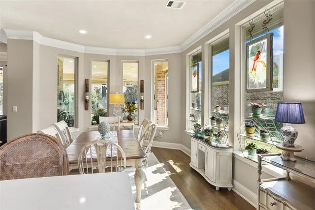 a living room with furniture and floor to ceiling windows