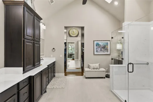 a en suite spacious bathroom with a double vanity sink a mirror and a shower