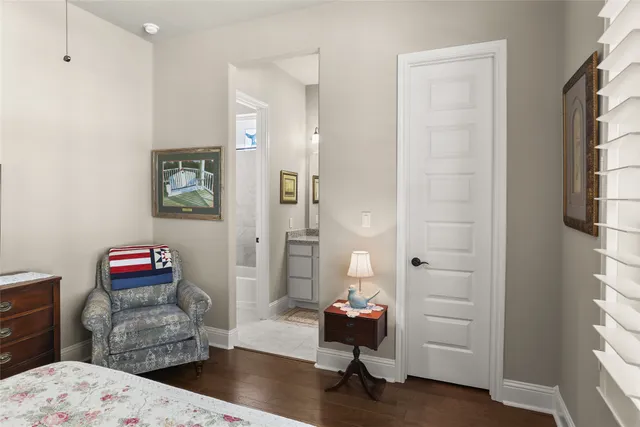a bedroom with furniture and a wooden floor