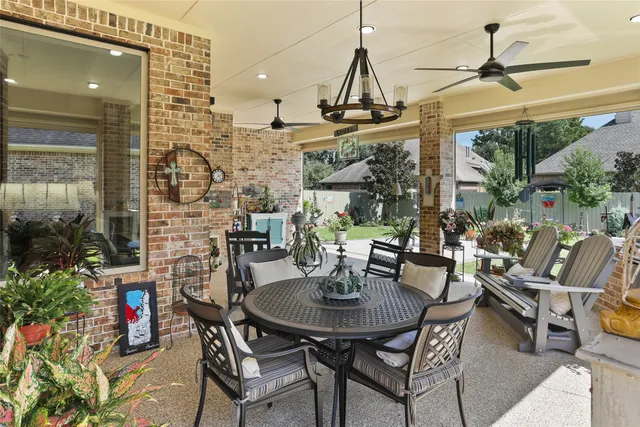 a view of an outdoor dining space with a table and chairs