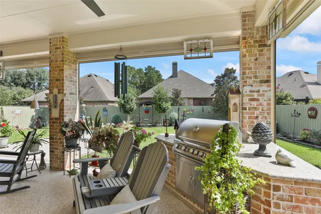 a view of a porch with furniture and garden