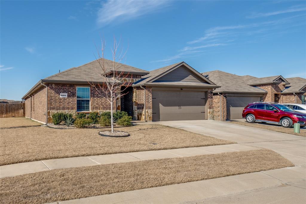 3204 Everly Drive Fate, TX 75189 - Photo 1 of 25 a front view of a house with parking area
