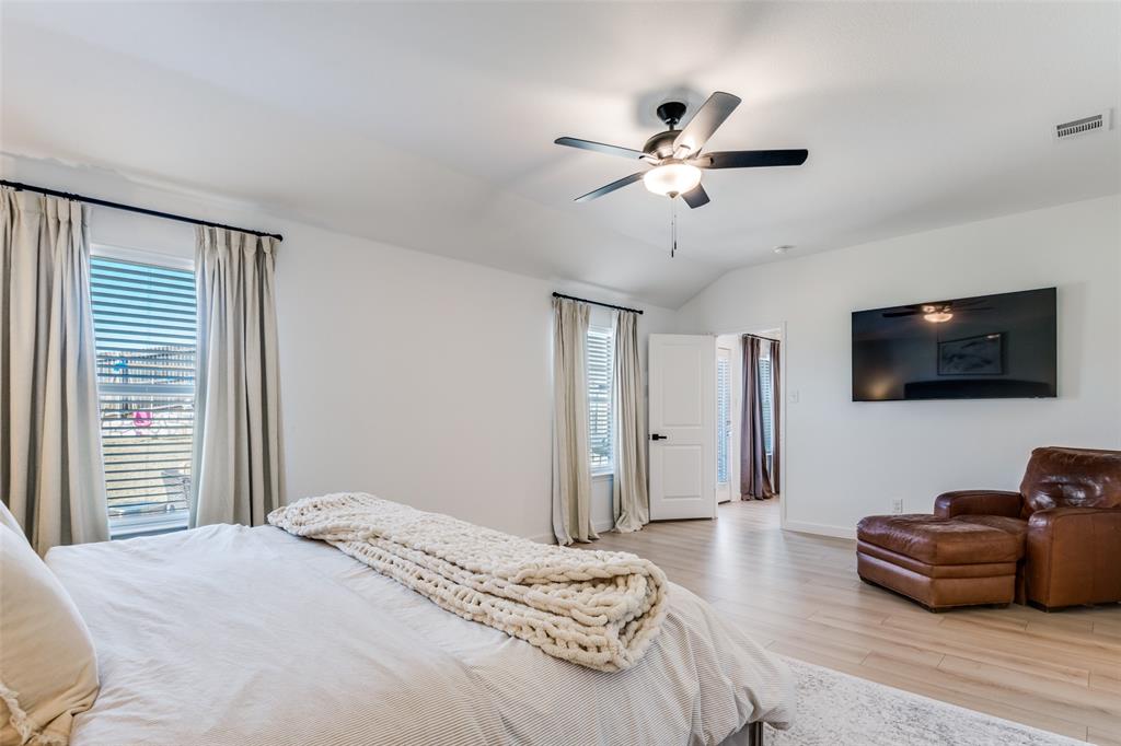 3204 Everly Drive Fate, TX 75189 - Photo 15 of 25 a bedroom with a bed a couch and a flat screen tv