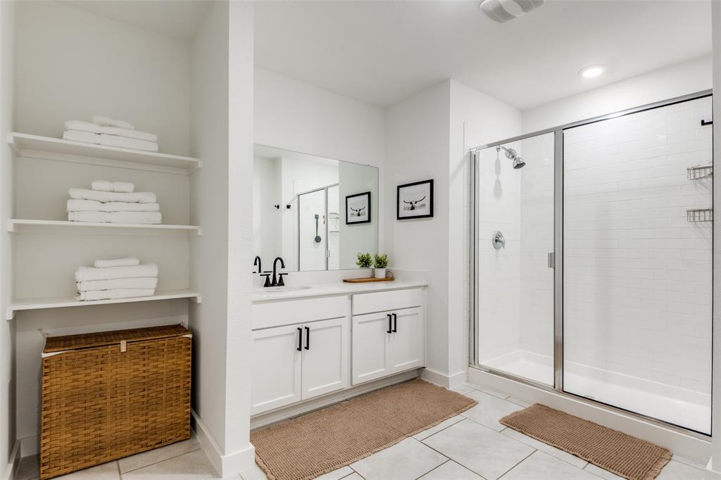 3204 Everly Drive Fate, TX 75189 - Photo 18 of 25 a spacious bathroom with a shower sink and mirror
