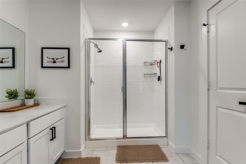 3204 Everly Drive Fate, TX 75189 - Photo 19 of 25 a bathroom with a shower and a sink