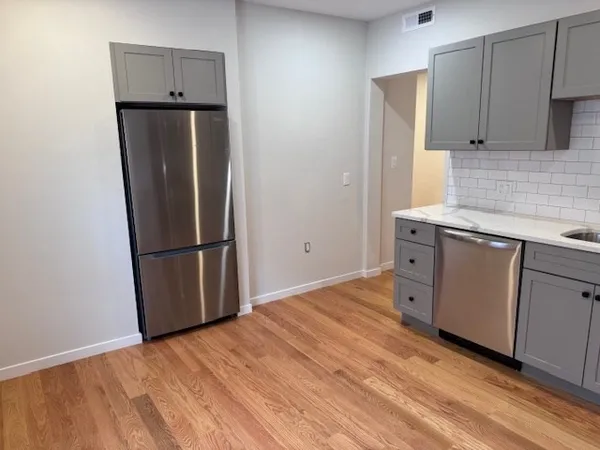 a kitchen with stainless steel appliances a stove a sink a microwave and cabinets