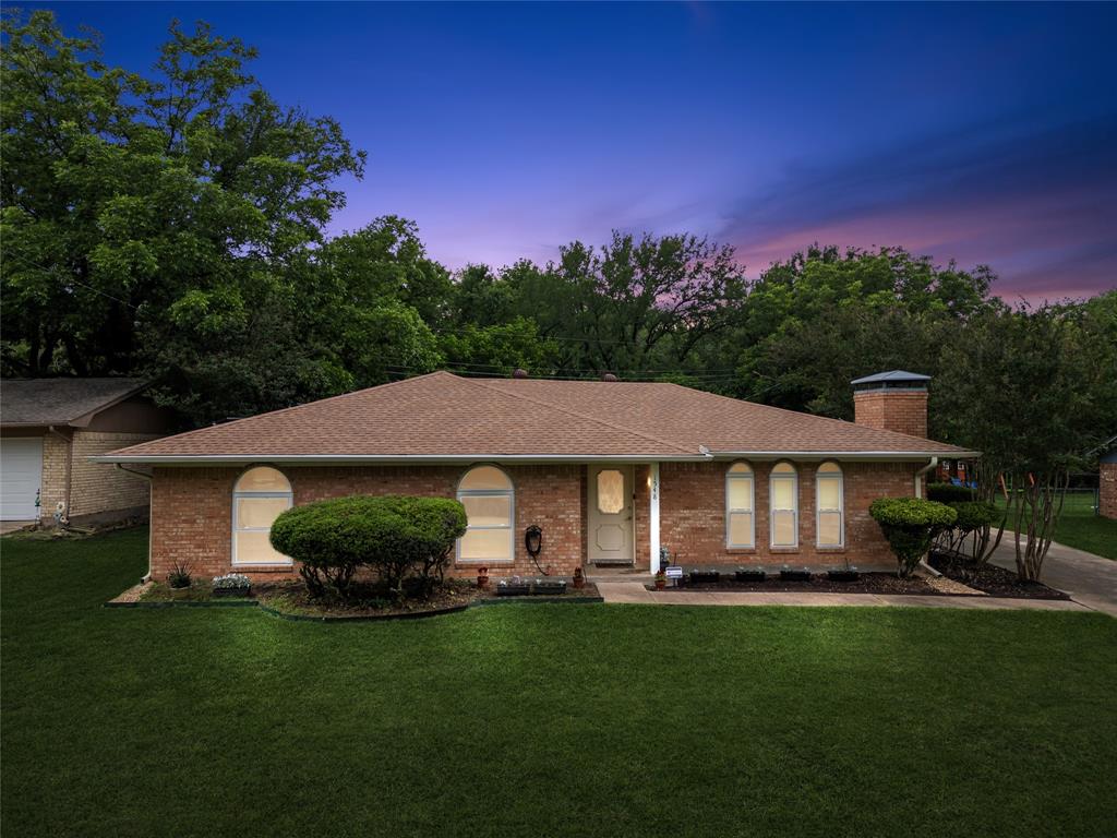 1548 Timbercreek Drive Howe, TX 75459 - Photo 2 of 24 a front view of a house with a garden