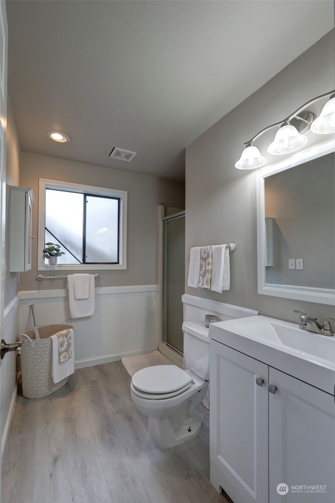 12404 Southeast 227th Street Kent, WA 98031 - Photo 16 of 21 a bathroom with a toilet a sink and mirror