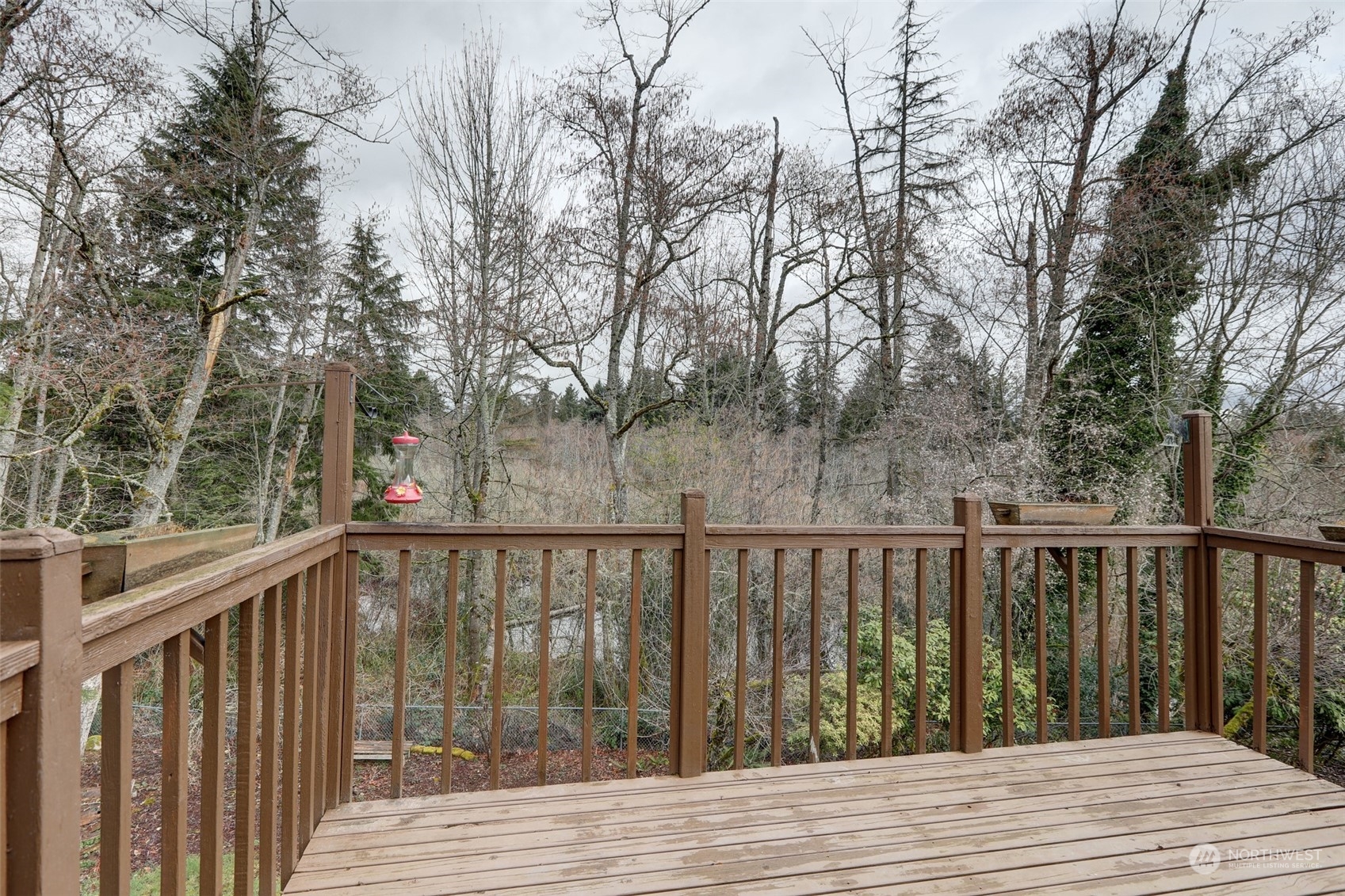 12404 Southeast 227th Street Kent, WA 98031 - Photo 18 of 21 a balcony with wooden floor and fence