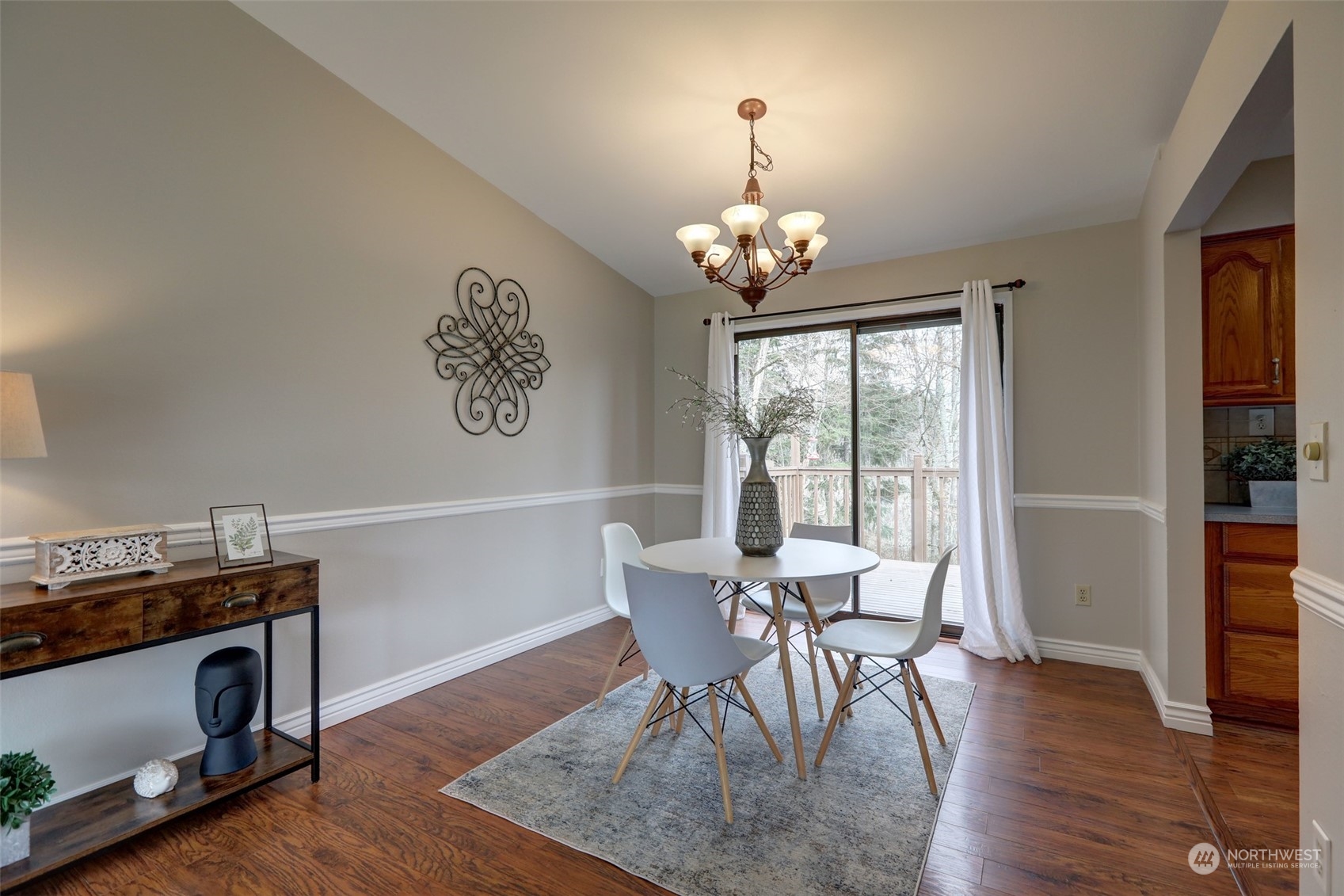 12404 Southeast 227th Street Kent, WA 98031 - Photo 5 of 21 a view of a dining room with furniture wooden floor and chandelier
