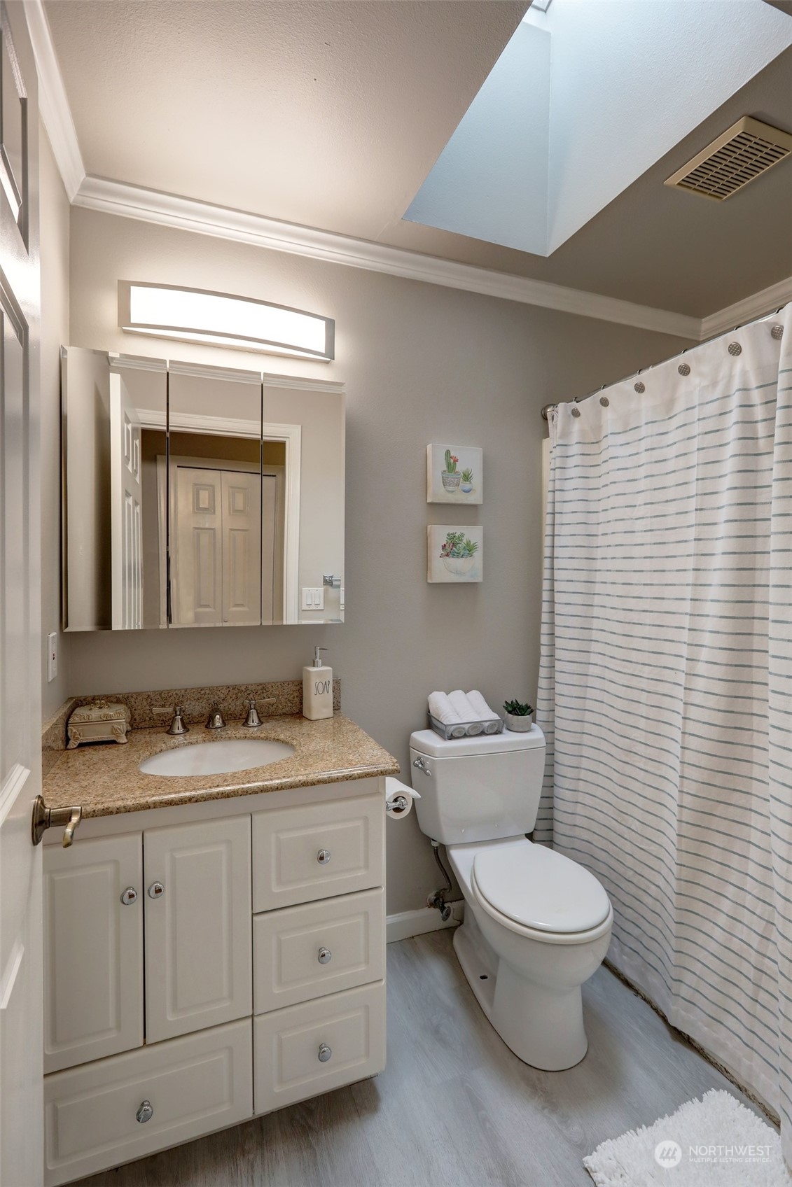 12404 Southeast 227th Street Kent, WA 98031 - Photo 7 of 21 a bathroom with a toilet sink and mirror