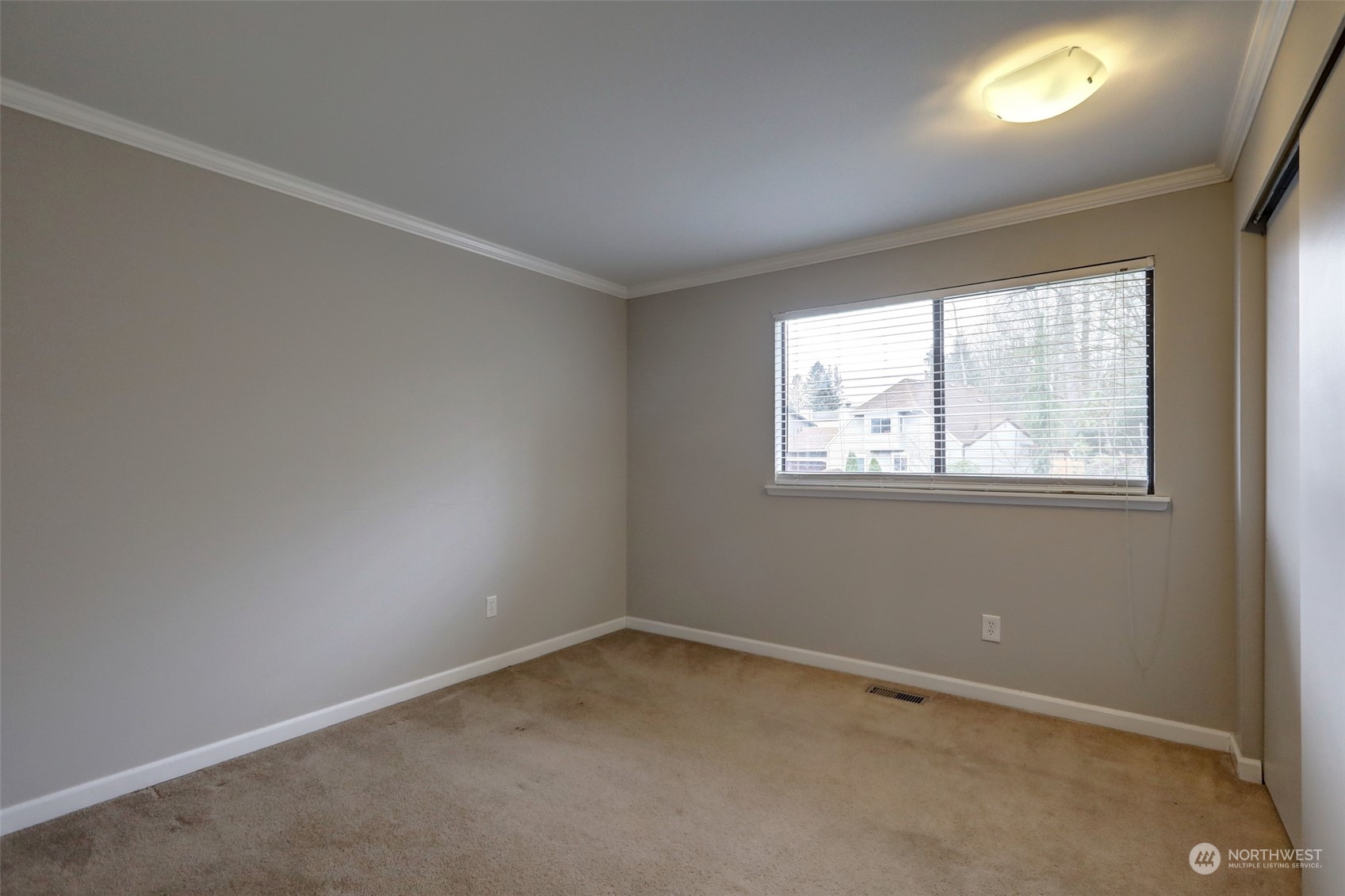 12404 Southeast 227th Street Kent, WA 98031 - Photo 9 of 21 an empty room with a window