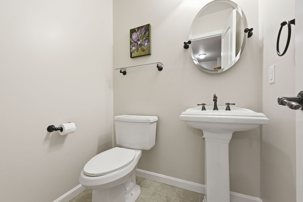 345 Bragg Road Warren, MA 01585 - Photo 20 of 41 a bathroom with a toilet sink and mirror