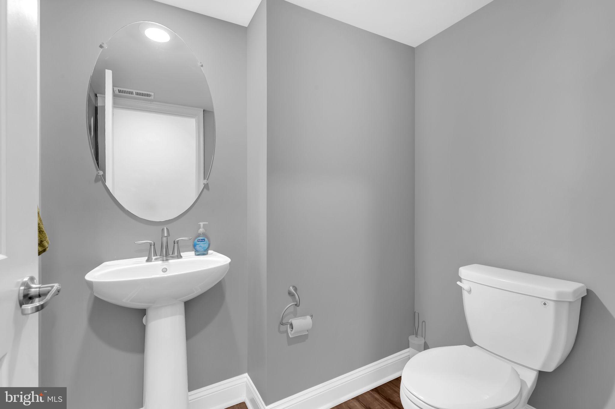 5007 East Joppa Road Perry Hall, MD 21128 - Photo 5 of 28 a bathroom with a toilet sink and mirror