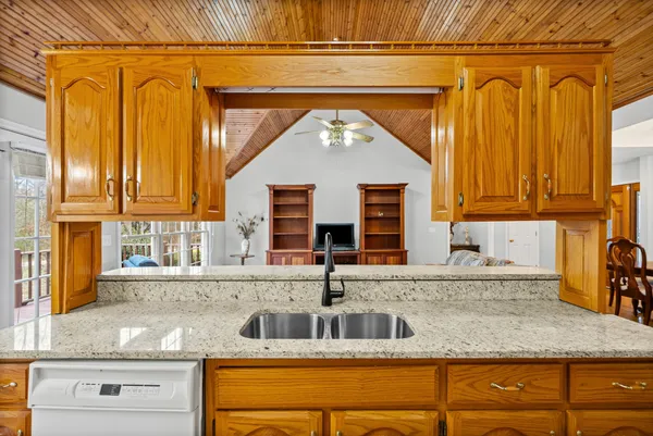 a kitchen with stainless steel appliances granite countertop a sink and a wooden cabinets