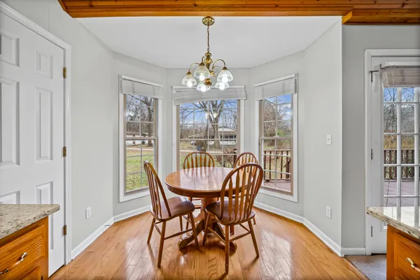 a view of a dining room with furniture wooden floor and chandelier